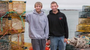 two men standing with lobster traps