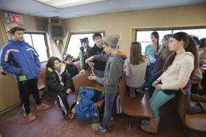 Younger mainland students gather in the passenger area of the ferry.