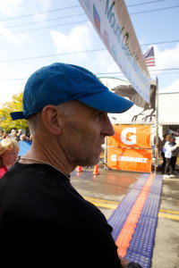man standing at race finish line awaiting winners