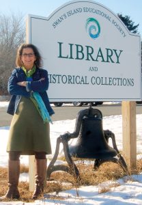 Candis Joyce standing in front of library sign