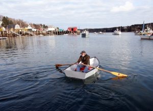 Brian Krafjack rows to his boat at its mooring.