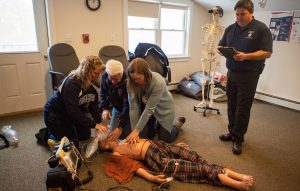 Vinalhaven's EMS volunteers demonstrate how they train to do CPR. From left: Denise Hopkins, Jeff Aronson, Sarah Crossman, and Marc Candage. PHOTO: JACK SULLIVAN