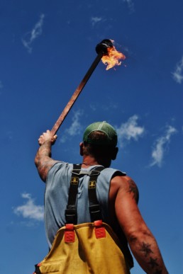 man in waders holding up torch