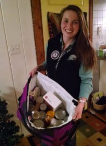 woman with bag of food drive donations