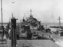 black and white photo of docked world war II vessels