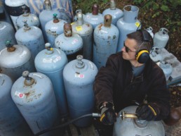 man with fuel tanks