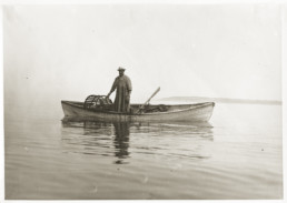 old photo of a man in a canoe