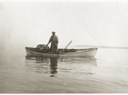 old photo of a man in a canoe