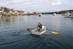 man rowing a dinghy