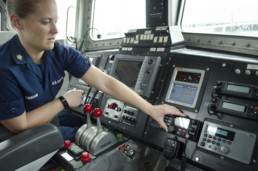 US coast guard woman working controls