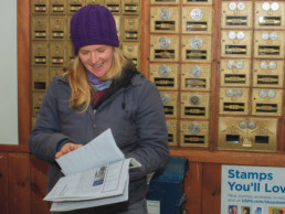 woman in post office rifling through papers